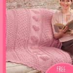 Aran Hearts Crocheted Throw. Beautiful pink hearts in center design of throw. Throw on sofa || thecrochetspace.com