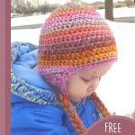 Seamless Crocheted Earflap Hat. Hat crafetd in oranges and pinks with earflaps || thecrochetspace.com