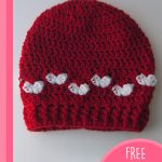 Baby Mine Crocheted Hat With Hearts. Crafted in red with white hearts || thecrochetspace.com