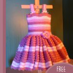 Baby's First Crochet Sundress. Crafted in pink stripes with a pink flower and a full skirt || thecrochetspace.com