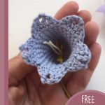 Blue Bell Crochet Flowers. Someone holding the head of the flower || thecrochetspace.com