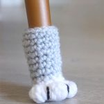 Cat-Paw Crochet Grey And White Chair Socks Shown On One Chair Foot Only || thecrochetspace.com
