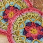 Colorful Spring Crocheted Potholder. Mandala crafted in gorgeous pinks, blues and greens || thecrochetspace.com