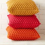 Crochet Bobbled Pillow. Three pillows stacked and crafted in different colors || thecrochetspace.com