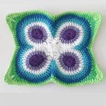 Crochet Butterfly Peacock Mandala. White background with green white, mauve and blue square || thecrochetspace.com