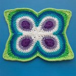 Crochet Butterfly Peacock Mandala. Blue background with green, white,mauve and blue square || thecrochetspace.com