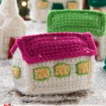 Crochet Christmas Festive Village. A couple of the smaller building sitting in snow || thecrochetspace.com