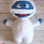 Crochet Christmas Snow Monster. Fuzzy white monster with flt white sharp teeth and a red tongue || thecrochetspace.com