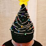 Crochet Christmas Tree Hat. Crafted in green with gold string beads, different colored accents and a bright yellow star on top || thecrochetspace.com