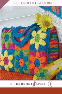 Crochet Flower Power Beach Bag. CRafted in colorful granny squares and crocheted handles || thecrochetspace.com
