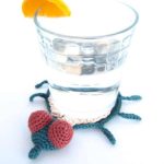 Crochet Fly Coasters. Glass standing on top of coaster || thecrochetspace.com