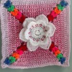 Crochet Granny Square Tulip. Crafted in pink and white with bold color accents || thecrochetspace.com