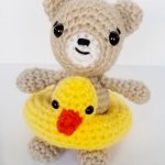 Crochet Summer Beach Teddy. Teddy sitting in his Duck ring || thecrochetspace.com