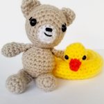 Crochet Summer Beach Teddy. teddy sitting beside hi Duck ring || thecrochetspace.com