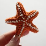 Crochet Summer Softie Starfish. One single orange starfish held between fingers || thecrochetspace.com