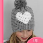 Crochet Valentine Heart Hat. Young girl wearing grey hat with heart || thecrochetspace.com