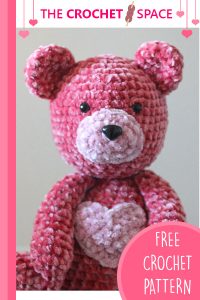 Crochet Velvet Valentine Bear. Pink bear with a pink heart on his tummy, close up || thecrochetspace.com