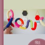 Crochet Words And Phrases. Word'Love' held between fingers || thecrochetspace.com