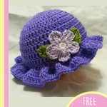 Crochet Young Ladies Hat With Flower. Crafted in purple with a brim and a flower || thecrochetspace.com