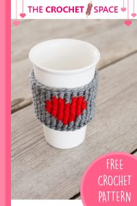 Crocheted Heart Cup Warmer. Grey warmer around a white plastic cup || thcecrochetspace.com