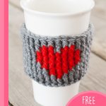 Crocheted Heart Cup Warmer. Close up of mug cozy on white plastic cup || thecrochetspace.com