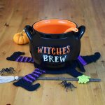 Crocheted Witch Table Coaster. A Witch's Brew pot on top of a flattened Witch || thecrochetspace.com