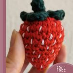 Easy Sweet Crocheted Strawberries. Image of one large strawberry with green leaves at top and white seeds dotted throughout || thecrochetspace.com