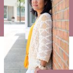 Forever Diamond Crochet Cardi. Image of woman leaning with her back against a brick wall, wearing a yellow tee, overlaid by a cream cardigan || thecrochetspace.com