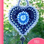 Grandma's Crochet Heart. Crafted in shades of blue. Heart hanging in a window || thecrochetspace.com