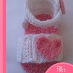 Heart Crocheted Baby Sandals. 1x white sandal with ankle strap, pink sole and pink accent heart || thecrochetspace.com