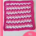 Higher Love Crochet Dishcloth. Square dishcloth with pink edging and rows of white and pink || thecrochetspace.com