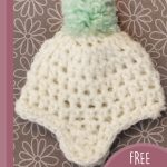 Keehan Baby Crochet Beanie. Crafted in cream with a light green pompom on top || thecrochetspace.com