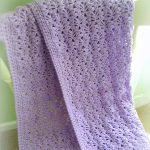 Lacy Crochet Baby Blanket. Lovely, light and airy baby blanket crafted in lilac || thecrochetspace.com