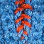 Mattress Stitch Seaming. Blue yarn with orange invisible seam || thecrochetspace.com