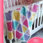 Patchwork Heart Crochet Blanket. Blanket on the side of a cot || thecrochetspace.com