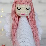 Pretty Crochet Snow Angel. White angel with pink hair and embroidered eyes || thecrochetspace.com