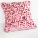 Pretty 'N Pink Crocheted. Pillow crafted in Hourglass Cable Stitch on one side || thecrochetspace.com
