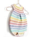 Rainbow Colors Crochet Romper. On a hanger, pleast at front. colored pastel lines with white inbetween || thecrochetspace.com