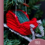 Santa's Festive Crochet Sleigh. Tiny sleigh hanging in Christmas tree. Crafted in red, green and silver || thecrochetspace.com