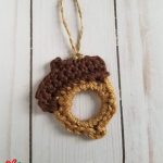 Seasonal Acorn Crochet Garland. One acorn on a hanger crafted in brown and beige || thecrochetspace.com