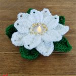 Seasonal-Poinsetta-Crochet-Garland. One flower crafted in white with candle || thecrochetspace.com
