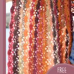 Self Striping Crochet Wrap. Multi colored wrap with close up image of stitches || thecrochetspace.com