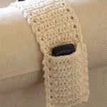 Simple Crochet Remote Organizer. Crafted in cream. One pocket either end of a strip. view shows one pocket only with remote inside || thecrochetspace.com