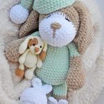 Sleepy Sonia Crochet Dog in Green outfit And Pointed Sleep Hat Laying With A Tiny Puppy Friend || thecrochetspace.com