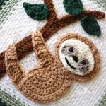 Super Sloth Crochet Blanket. Up Close image of sloth in middle of blanket, and cluthing a tree || thecrochetspace.com