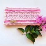 Sweetest Pea Crochet Headband. Pictured with a pink bouganvilla. Crafted in pale pink with dark pink Camel stitch rows || thecrochetspace.com