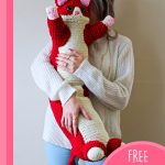 Valentine Crochet kitty Pillow. Someone cradling a kitty pillow || thecrochetspace.com