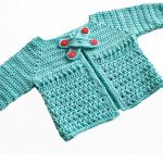 X Stitch Crocheted Baby Cardigan. Close up image of cardigan on the diagonal || thecrochetspace.com
